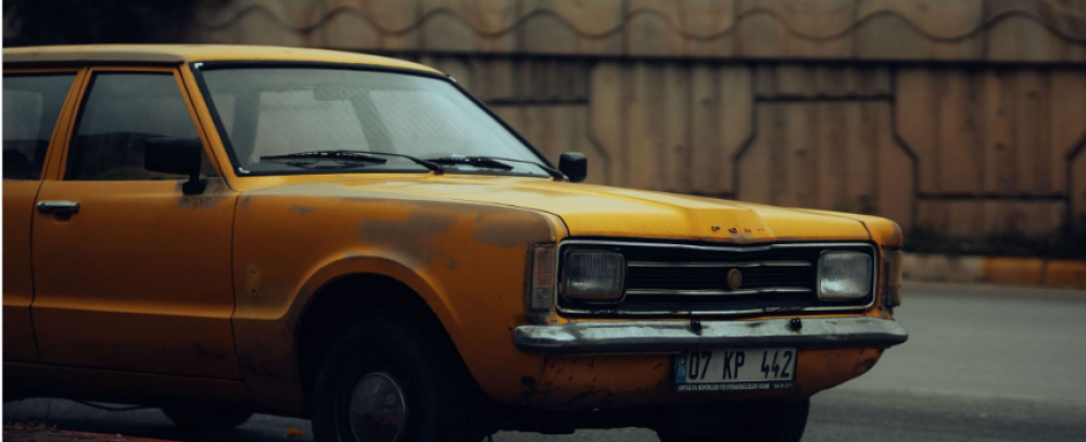 (Photo credit: https://www.pexels.com/photo/vintage-yellow-car-parked-on-urban-street-29879059/)