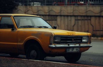 (Photo credit: https://www.pexels.com/photo/vintage-yellow-car-parked-on-urban-street-29879059/)