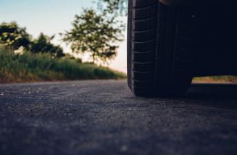 Car on road centered on tyre